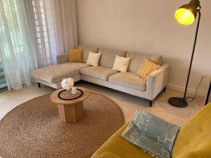 a living room with a couch and a table at Seaside Escape with Breathtaking View in Grand Gaube