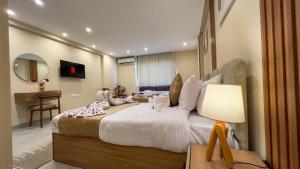 Un dormitorio con una cama grande y una mesa con lámpara. en pyramids palace view, en El Cairo