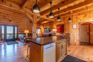 a kitchen with a island in a wooden cabin at Grand Vista Lodge in West Jefferson
