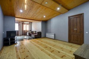 an empty room with a wooden floor and a door at Aleqs in Tbilisi City