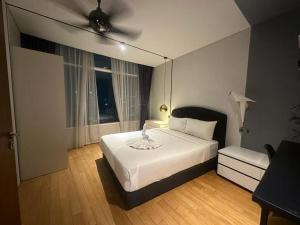 a bedroom with a bed and a ceiling fan at Vortex suites klcc by Kualalampur vibes in Kuala Lumpur