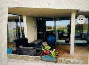 a living room with a couch and chairs and windows at Snäckbacken Visby in Visby