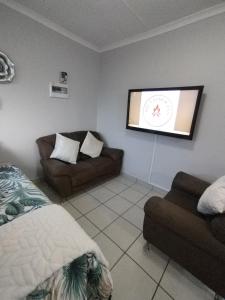 a bedroom with a bed and a flat screen tv at The Gather Inn Bethlehem in Bethlehem