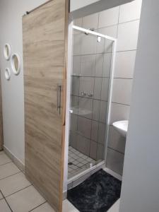 a shower with a glass door in a bathroom at The Gather Inn Bethlehem in Bethlehem