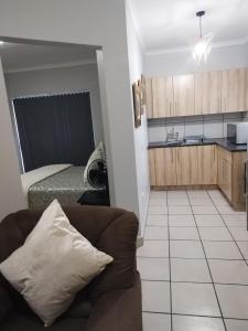 a living room and kitchen with a couch and a bed at The Gather Inn Bethlehem in Bethlehem +4 photos