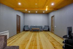 a living room with a couch and a table in a room at Aleqs in Tbilisi City