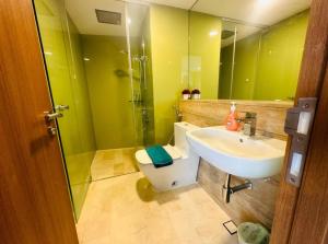 a bathroom with a sink and a toilet and a mirror at Vortex suites klcc by Kualalampur vibes in Kuala Lumpur