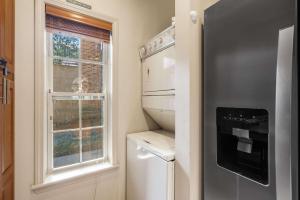 a small kitchen with a refrigerator and a window at Fairway To Heaven - For 8ppl in Branson West