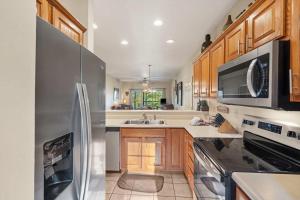 a kitchen with a stainless steel refrigerator and a sink at Fairway To Heaven - For 8ppl in Branson West +17 photos