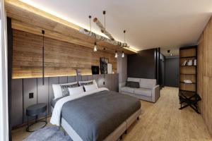 a bedroom with a large bed and a chair at Jezerní Rezidence in Železná Ruda