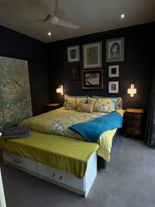 a bedroom with a bed and pictures on the wall at Franschhoek Guest Suite in Franschhoek