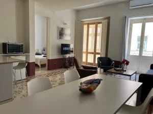a living room with a table with a bowl of fruit on it at Charming Apartment in the Heart of Valletta in Valletta