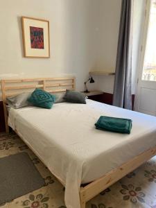 a bed with two pillows on it in a bedroom at Charming Apartment in the Heart of Valletta in Valletta