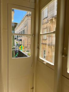 an open door with a view of a building at Charming Apartment in the Heart of Valletta in Valletta