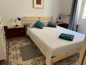 a bedroom with a bed with two pillows on it at Charming Apartment in the Heart of Valletta in Valletta