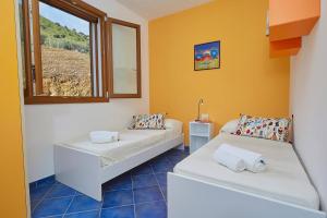 a room with two beds and a window at VILLA ANANDA in Scopello +56 photos