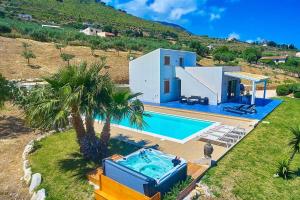 an aerial view of a house with a swimming pool at VILLA ANANDA in Scopello