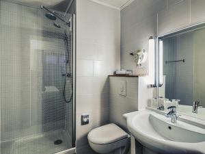 a bathroom with a toilet and a sink and a shower at Mercure Albi Rives du Tarn in Albi