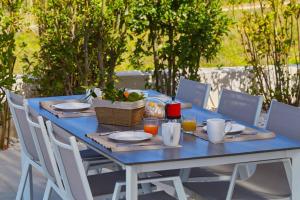 a blue table with plates of food on it at Villa Biancolilla in Castellammare del Golfo