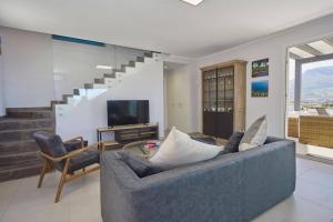 a living room with a couch and a television at Villa Biancolilla in Castellammare del Golfo