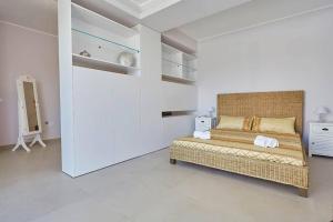 a bedroom with a large bed in a white room at Villa Biancolilla in Castellammare del Golfo +27 photos