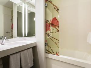 a bathroom with a sink and a mirror at Mercure Bordeaux Centre Ville in Bordeaux +111 photos