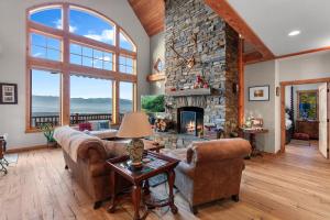 a living room with a couch and a stone fireplace at 818Forever in Lignite