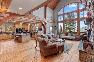 a large living room with wooden floors and large windows at 818Forever in Lignite