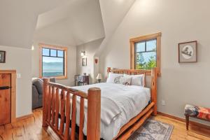 a bedroom with a wooden bed and two windows at 818Forever in Lignite