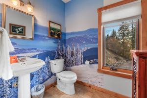 a bathroom with a toilet and a sink and a window at 818Forever in Lignite +22 photos