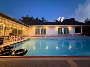 a large swimming pool in front of a house at Avare House Krabi in Ao Nam Mao +62 photos