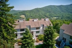 an aerial view of a large house with mountains in the background at Top Of Seven in Seven Devils