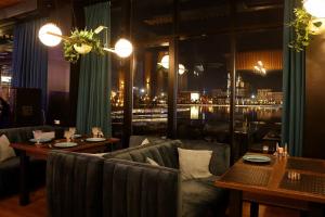 a restaurant with couches and tables and a view at BOULEVARD NEST RESlDENCE in Tashkent