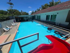 a large swimming pool with a slide on a building at Avare House Krabi in Ao Nam Mao