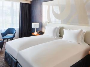 Ένα ή περισσότερα κρεβάτια σε δωμάτιο στο Sofitel Luxembourg Europe +107 φωτογραφίες