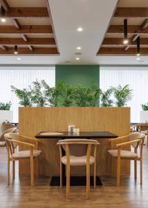 a conference room with tables and chairs and plants at Вілла "Синевір" in Skhidnitsa +55 photos