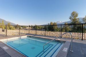 a swimming pool on a balcony with mountains in the background at Fairfield by Marriott Inn & Suites Revelstoke in Revelstoke