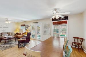 a living room with a couch and a ceiling fan at Summer House in Edisto Beach