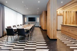 a conference room with a long table and chairs at MONDI Hotel Bellevue Gastein in Bad Gastein +64 photos