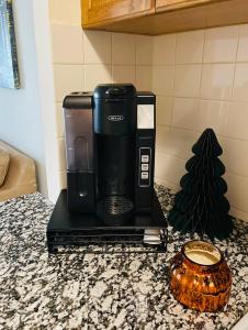 a coffee maker sitting on top of a counter at Spacious 2br2ba With Hardwood Floors in Cheltenham Village +5 photos