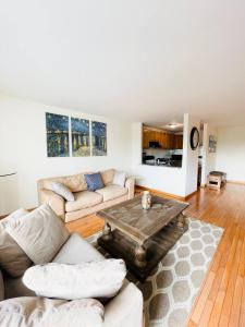 a living room with a couch and a coffee table at Spacious 2br2ba With Hardwood Floors in Cheltenham Village