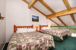 due letti in una stanza con soffitti in legno di (A204) Loft Condominiums a Yosemite West
