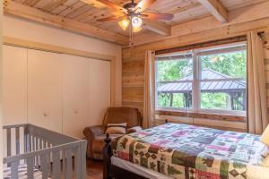 a bedroom with a bed and a ceiling fan at Serenity Now in Fleetwood