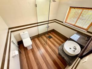a bathroom with a toilet and a sink and a shower at Almond Villa in Kappil +22 photos