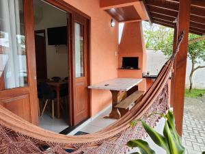 a hammock on the porch of a house at Partiu Praia SC- Piscina, Ar condicionado, wi-fi, duas quadras da praia e centrinho in Pinheiro
