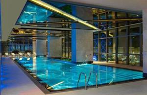 a large swimming pool in a large building at BOULEVARD NEST RESlDENCE in Tashkent +27 photos