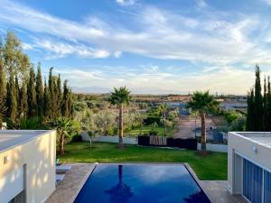 a view from the balcony of a house with a swimming pool at Villa Zaara in Sehib Foukani