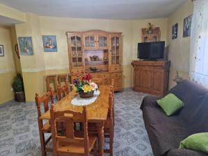 a living room with a table and a couch at Rincón del Descanso in La Iruela