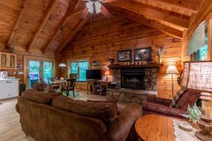 a living room with a couch and a fireplace at Trillium in Banner Elk