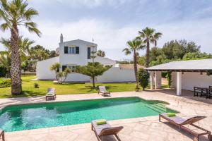 a villa with a swimming pool and a house at Los Olivos - Casa rural en exclusiva finca privada in Sant Lluis